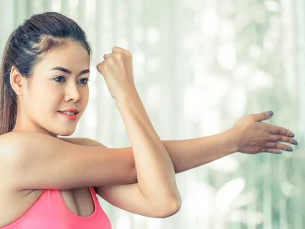 Sporty woman doing arm stretching — Stock Photo, Image