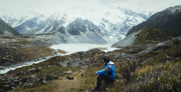 Mountain hiker traveling in wilderness landscape.