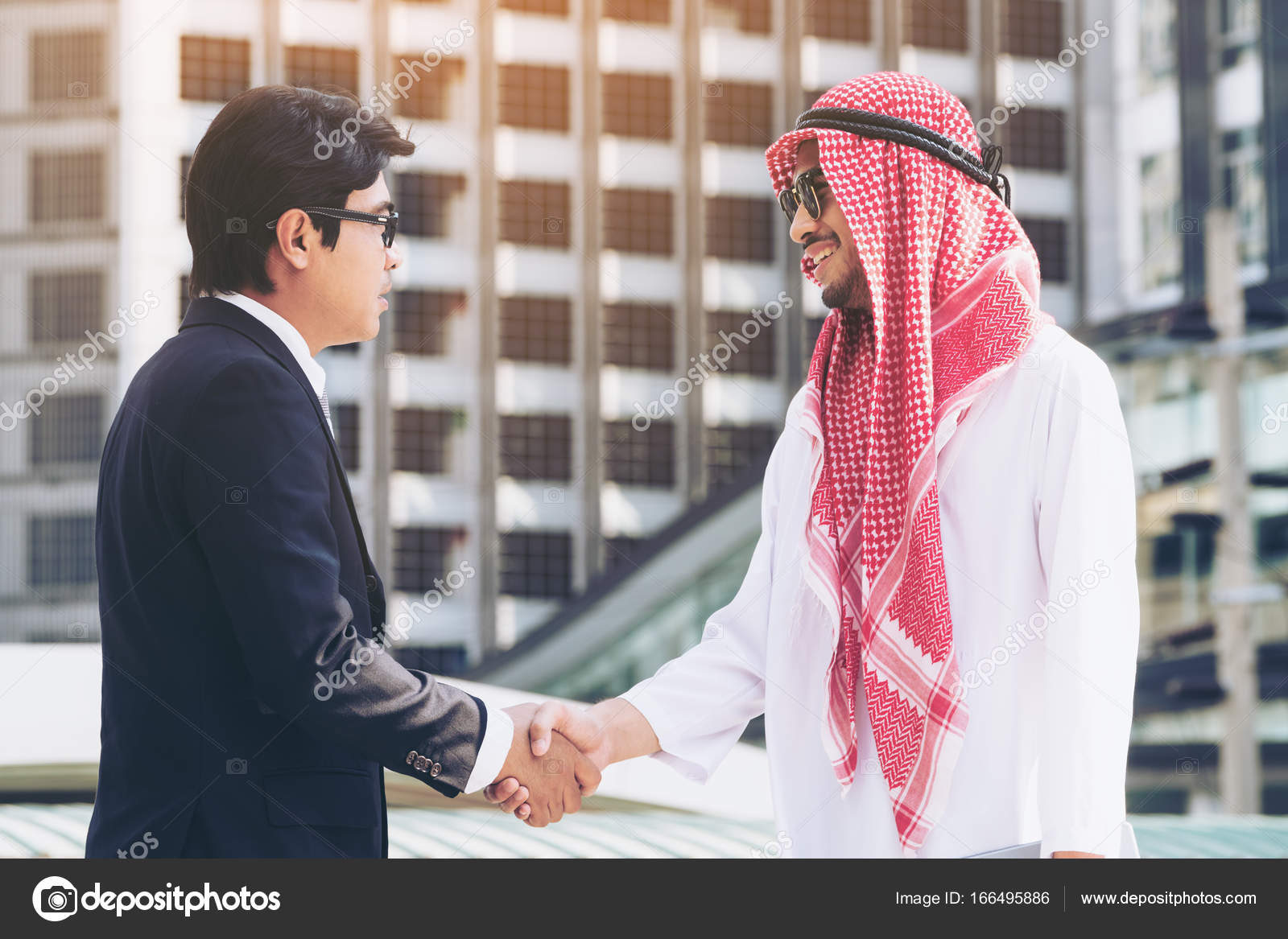 Arab man and businessman handshake Stock Photo by ©BiancoBlue 166495886