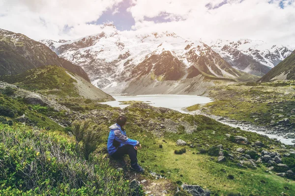 Mountain hiker traveling in wilderness landscape.