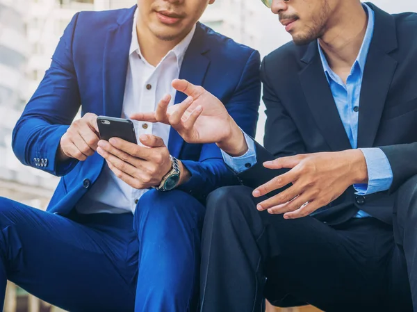 Two business people discuss business affair on mobile phone