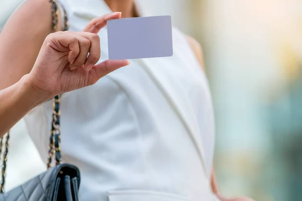 Businesswoman showing white empty card
