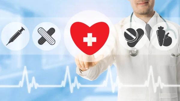 Doctor pointing at heart icon on blue background. — Stock Photo, Image