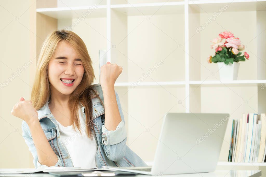 Excited young woman showing accomplishments.