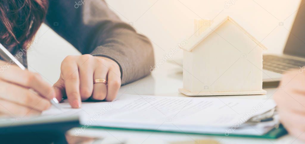 Client Signs Document to Buy House and Real Estate