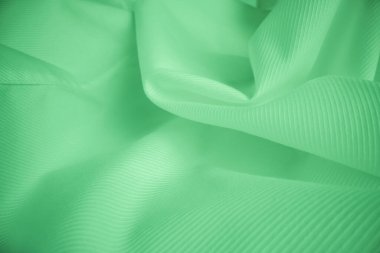 Makro çekimde parlak akan bez dokusu. Dalgalı temiz ipek difa malzemesi. Tekstil soyut arka plan.