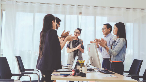 Successful business people group celebrating project success at office. Team winner and collaboration achievement concept.