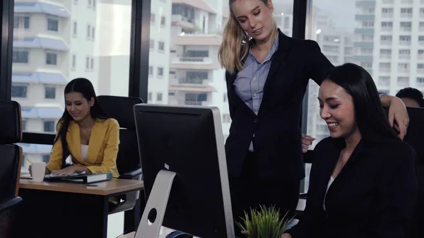 Young leader gives advice to young woman worker in modern office. Leadership and training concept.;Young leader gives advice to young woman worker in modern office. Leadership and training concept.