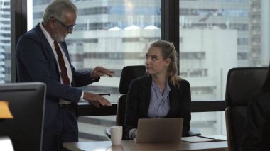 Üst düzey yönetici modern ofisteki genç kadın çalışana tavsiyelerde bulunuyor. Liderlik ve eğitim konsepti. ; Modern ofisteki genç kadın çalışana kıdemli yönetici tavsiyelerde bulunur. Liderlik ve eğitim kavramı.