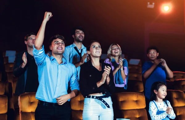 Group of audience happy and fun watch cinema in movie theater. Group recreation activity and entertainment concept.