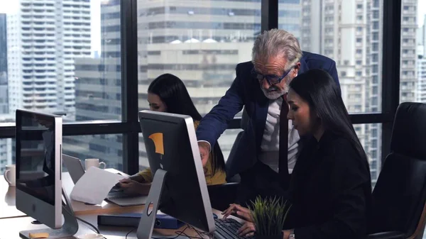 Senior manager gives advice to young woman worker in modern office. Leadership and training concept.;Senior manager gives advice to young woman worker in modern office. Leadership and training concept.