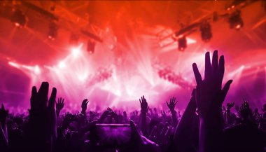 Happy people dance in nightclub DJ party concert and listen to electronic dancing music from DJ on the stage. Silhouette cheerful crowd celebrate New Year party 2020. People lifestyle DJ nightlife.;Happy people dance in nightclub DJ party concert and