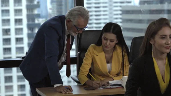 Senior manager gives advice to young woman worker in modern office. Leadership and training concept.;Senior manager gives advice to young woman worker in modern office. Leadership and training concept.