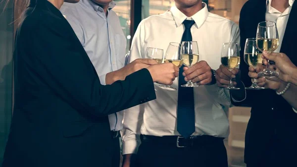 Successful business people drink wine and champagne with team members in ball room to celebrate business project to launch new product to market. Corporate business and people networking concept.;Successful business people drink wine and champagne wi