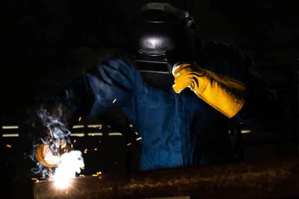 金属焊机与电弧焊机一起工作 在工厂焊接钢时穿着安全设备 按手工技能劳动概念分列的金属加工制造和建筑维修服务 — 图库照片