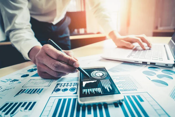 Businessman accountant or financial expert analyze business report graph and finance chart at corporate office. Concept of finance economy, banking business and stock market research.