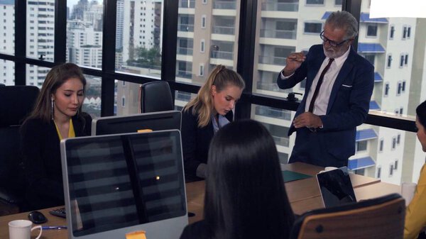 Professional business people discuss financial issue in group meeting at company office. Global business and brainstorming concept.