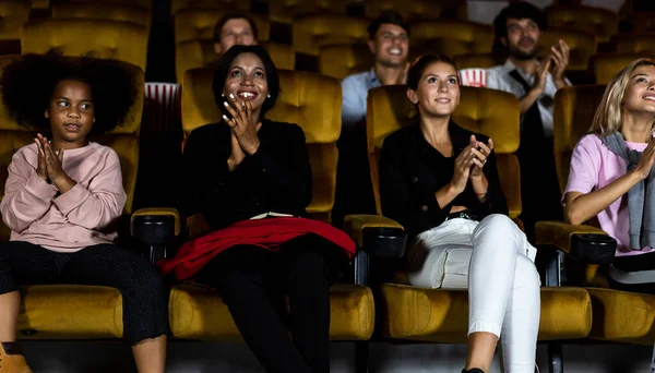 People audience watching movie in the movie theater cinema. Group recreation activity and entertainment concept.