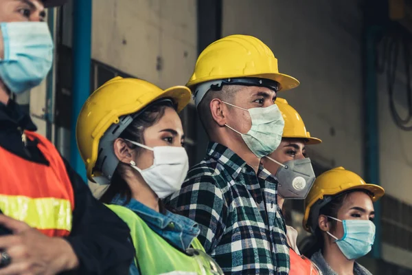 Factory workers with face mask protect from outbreak of Corona Virus Disease 2019 or COVID-19.