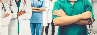 2019 Coronavirus hastalığı ya da COVID-19 ile savaşmak için hastanede çalışan bir doktor. Diğer doktorlar, hemşire ve cerrahlarla birlikte profesyonel sağlık görevlileri. Corona Virüsü Tıbbi Bakım ve Koruma Konsepti.