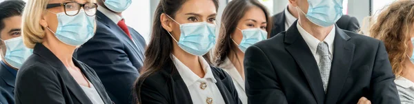 Confident business people with face mask protect from Coronavirus or COVID-19. Concept of help, support and collaboration together to overcome epidemic of Coronavirus or COVID-19 to reopen business.