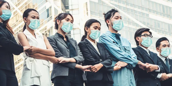 Confident business people with face mask protect from Coronavirus or COVID-19. Concept of help, support and collaboration together to overcome epidemic of Coronavirus or COVID-19 to reopen business.