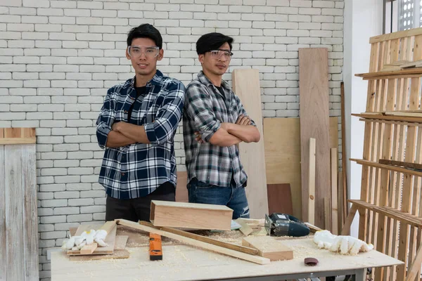 Carpenter working on wood craft at workshop to produce construction material or wooden furniture. The young Asian carpenter use professional tools for crafting. DIY maker and carpentry work concept.