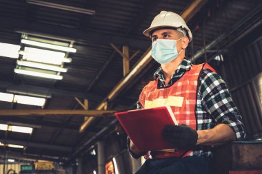 Yüz maskesi olan fabrika işçileri Coronavirus hastalığı salgınından koruyorlar. 2019 veya COVID-19. Koronavirüs hastalığının 2019 veya COVID-19 'un yayılmasını engellemek için koruma ve karantina kavramı.