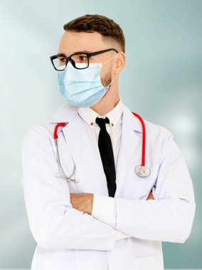 Doktor hastanede yüz maskesi takıyor. Coronavirus hastalığı ya da COVID-19 'dan korunuyor. Sağlık personeli, Coronavirus hastalığı veya COVID-19 enfeksiyonu kapan yüksek riskli kişilerdir..