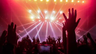Mutlu insanlar gece kulübü DJ parti konserinde dans eder ve sahnede DJ 'den elektronik dans müziği dinlerler. Siluet dolu neşeli kalabalık 2020 yılbaşı partisini kutluyor. İnsanların yaşam tarzı DJ gece hayatı.