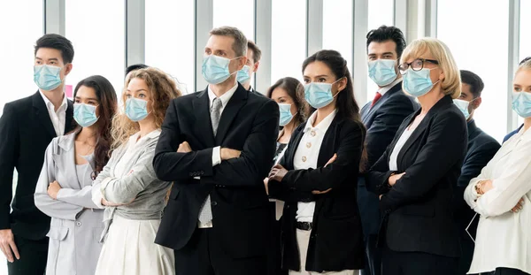 Confident business people with face mask protect from Coronavirus or COVID-19. Concept of help, support and collaboration together to overcome epidemic of Coronavirus or COVID-19 to reopen business.