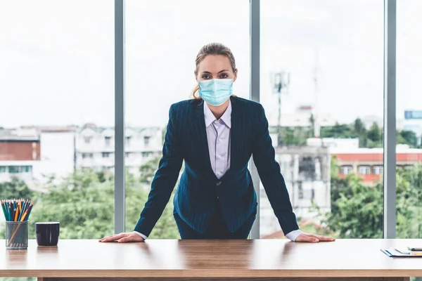 Office worker with face mask quarantine from coronavirus or COVID-19. Concept of protective working environment to reopen business and stop spreading of coronavirus or COVID-19.