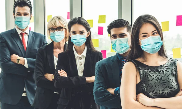 Confident business people with face mask protect from Coronavirus or COVID-19. Concept of help, support and collaboration together to overcome epidemic of Coronavirus or COVID-19 to reopen business.