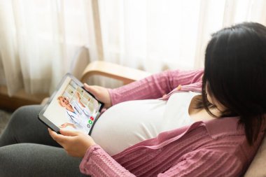 Doctor telemedicine service online video with pregnant woman for prenatal care . Remote doctor healthcare consultant from home using online mobile device connect to internet for live video call . clipart